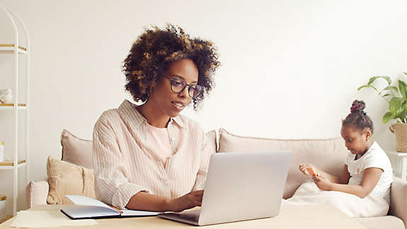 A woman looking at her insurance policy on her laptop.