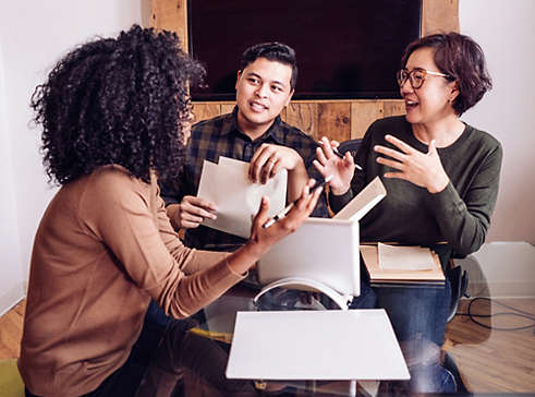 Three people in the office talking