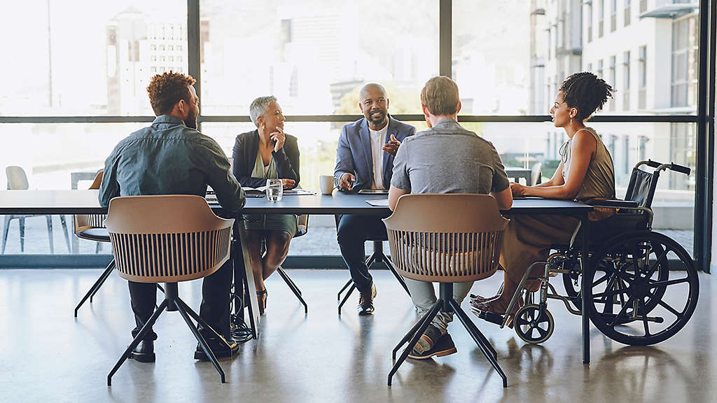 A diverse group of people sitting at a conference table