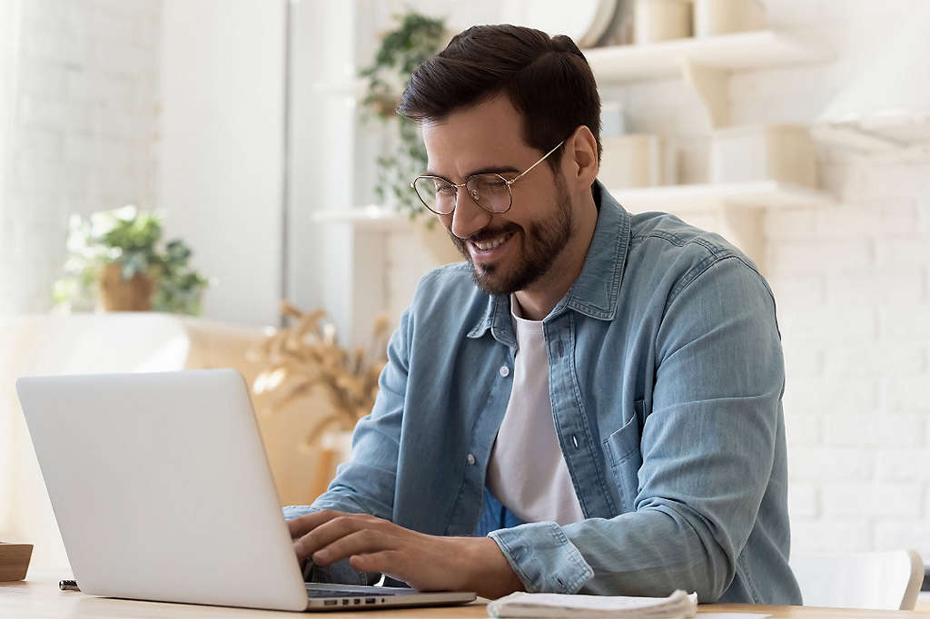 Man at computer researching ETFs (Exchange-traded funds)