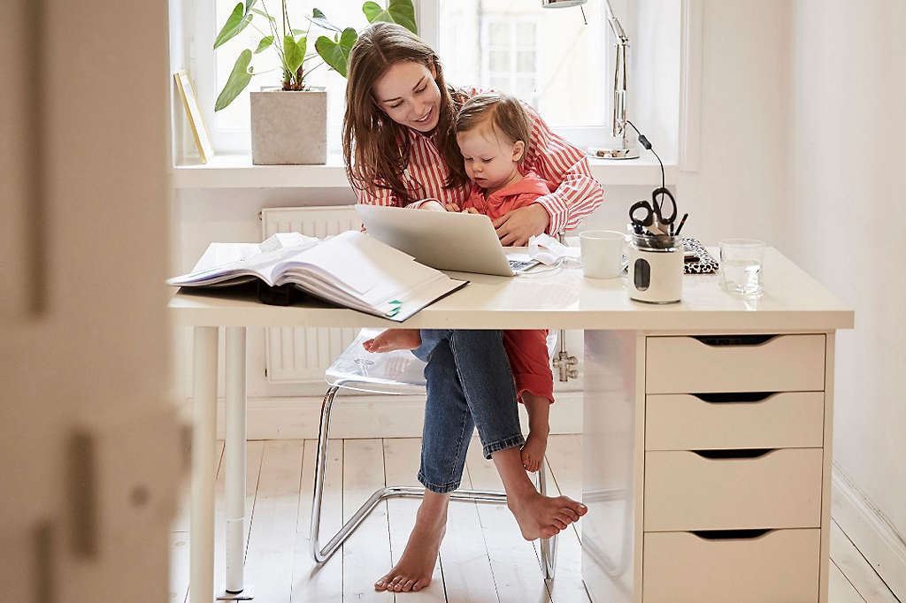 Mother using computer with her child