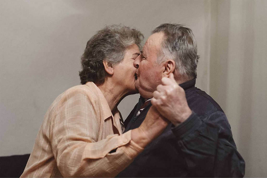 An elderly couple embracing, knowing their future is secure. 