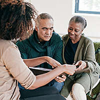 Agent going over paperwork with older couple.