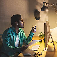 Black Businessman Using Mobile Phone