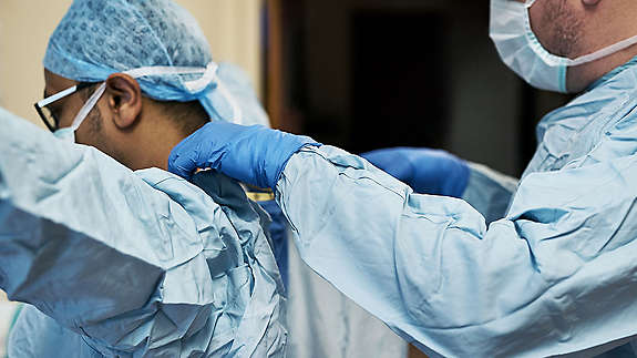 A doctor helping another doctor