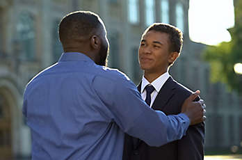 A father with his son outside a college