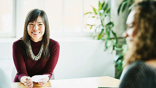 happy woman in meeting with clients in office conference room
