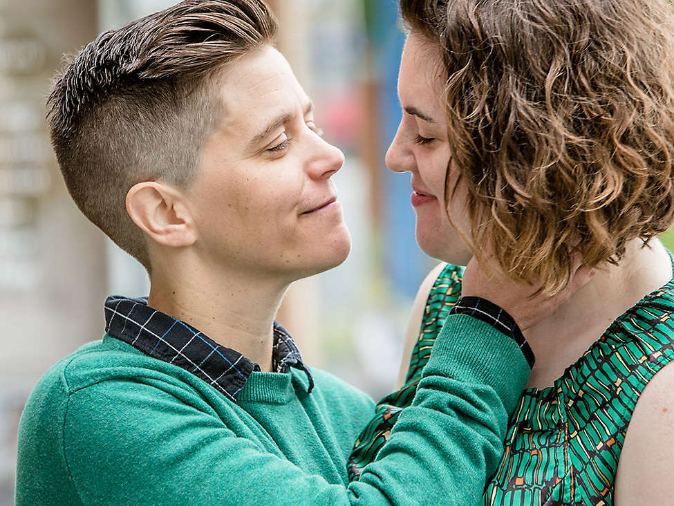 Lesbian couple embraces outside