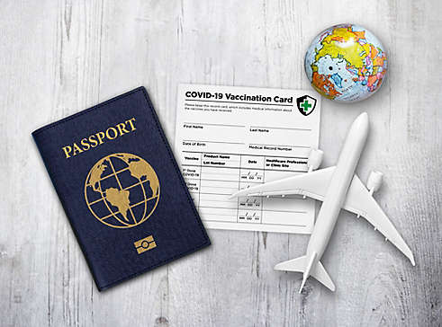 A travel theme with passport and COVID Vaccination Card