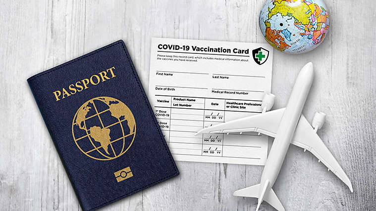 A travel theme with passport and COVID Vaccination Card