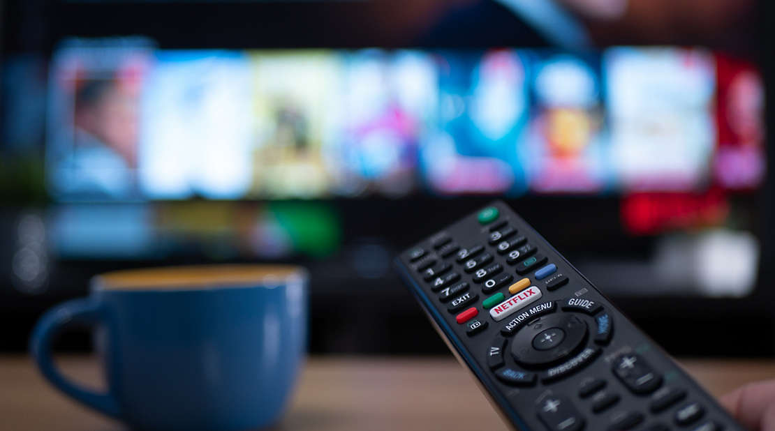  A television remote and a coffee cup