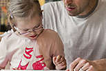 Dad reading to his daughter