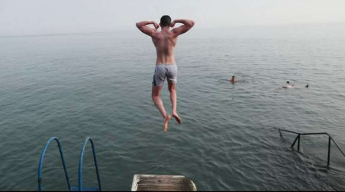  A person diving into a lake
