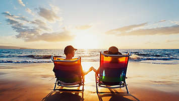 A couple watching the sunset on the beach