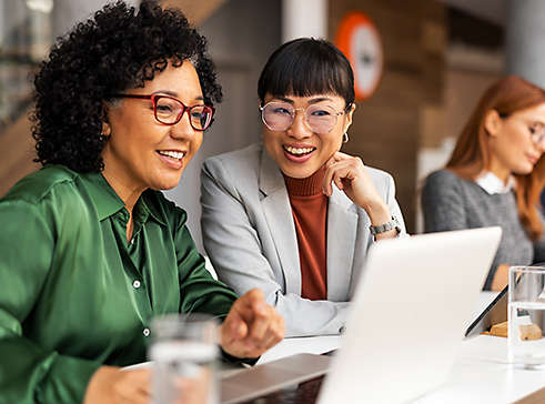 Employees looking at their laptop