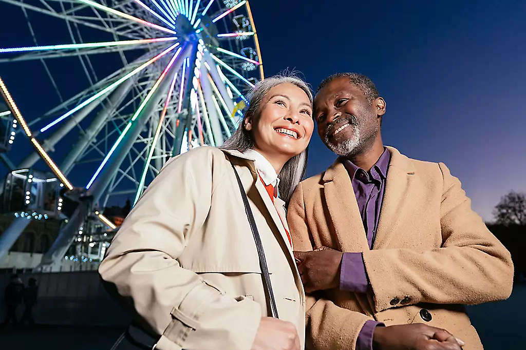 Woman and man outside of a ferris wheel