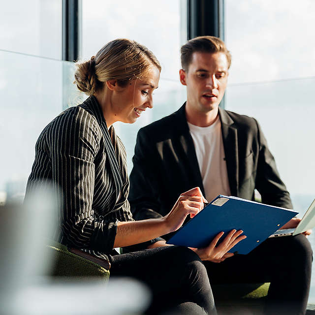 A woman and man talking to eachother at work
