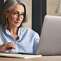 Middle aged woman working at laptop