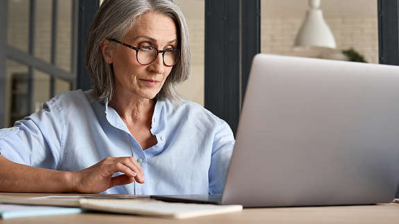 middle aged woman on laptop at home.