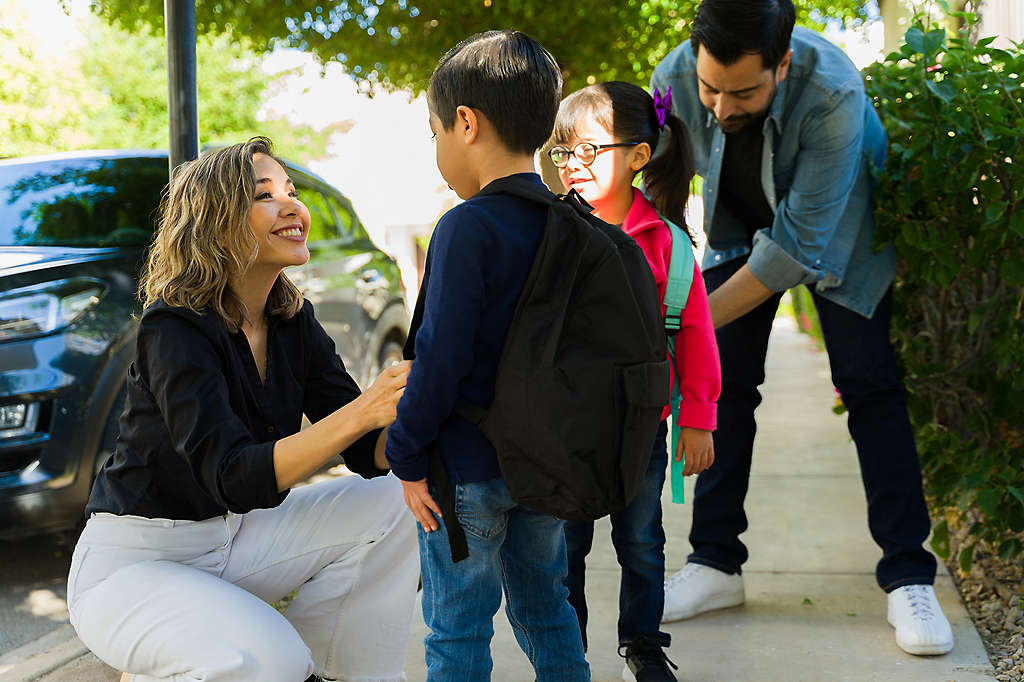 A couple dropping their children off at school