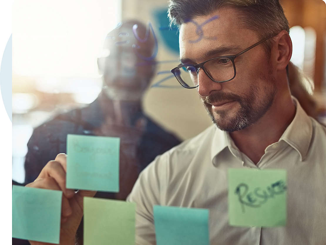 Financial professional writes on whiteboard