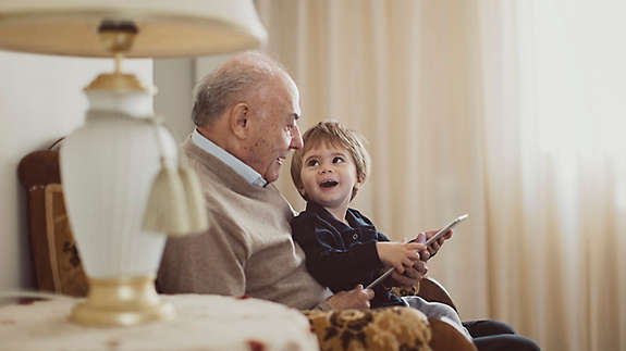 Grandfather and grandchild reading