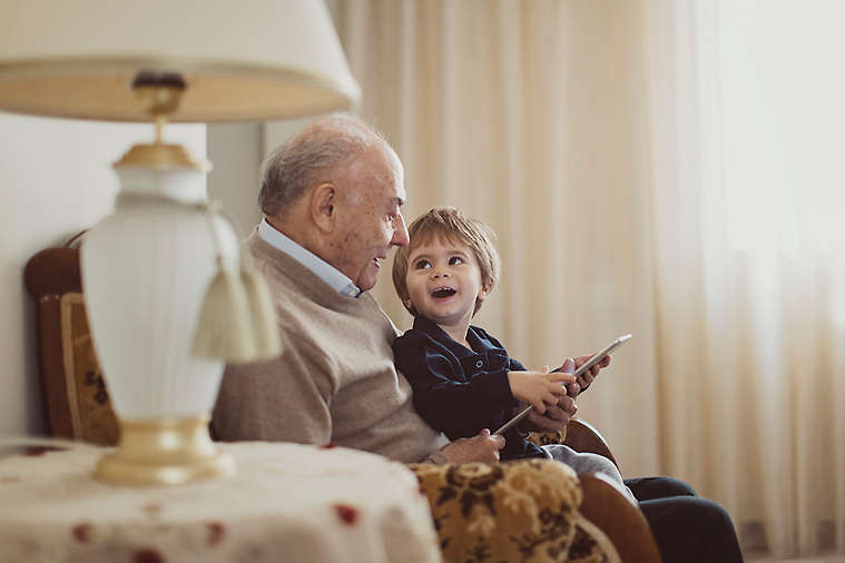 Grandfather and grandchild reading