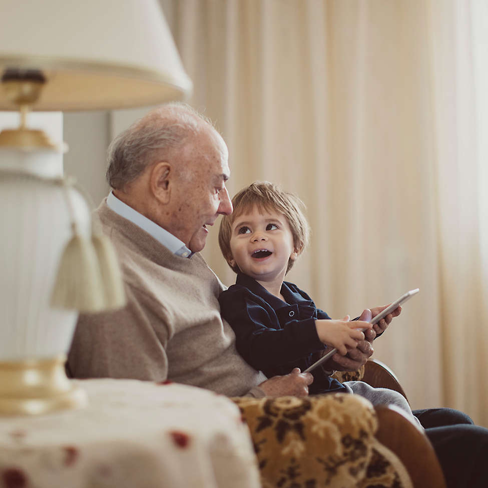 Grandfather and grandchild reading