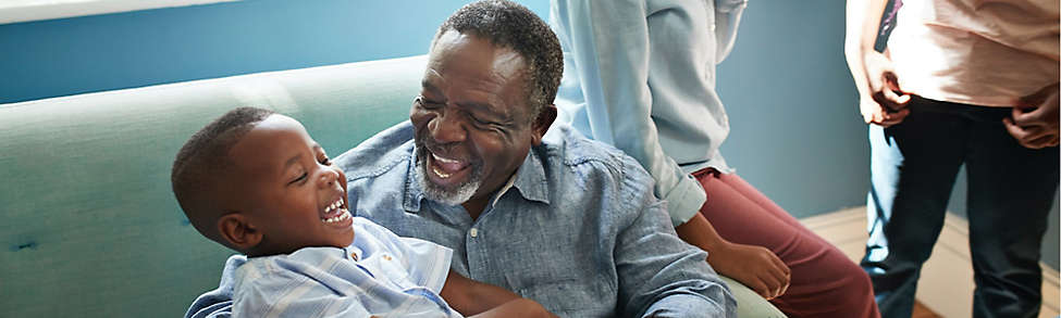 Grandfather holding grandchild smiling