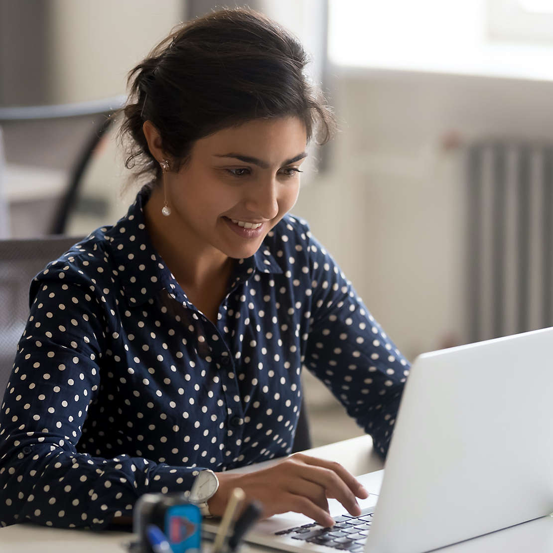 Woman typing on a laptop