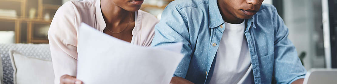 Couple reviewing paperwork in their home.