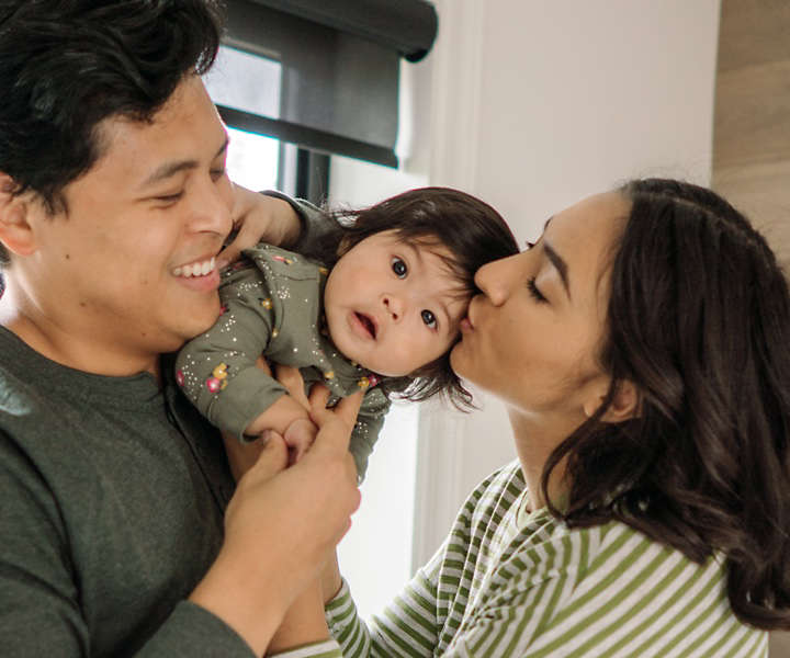 Mother and Father holding child