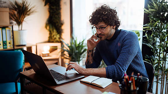 Man sitting at his desk on the phone 