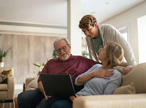 Grandparents talking to grandchild in livingroom