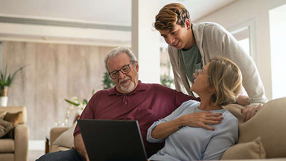 Grandparents talking to grandchild in livingroom