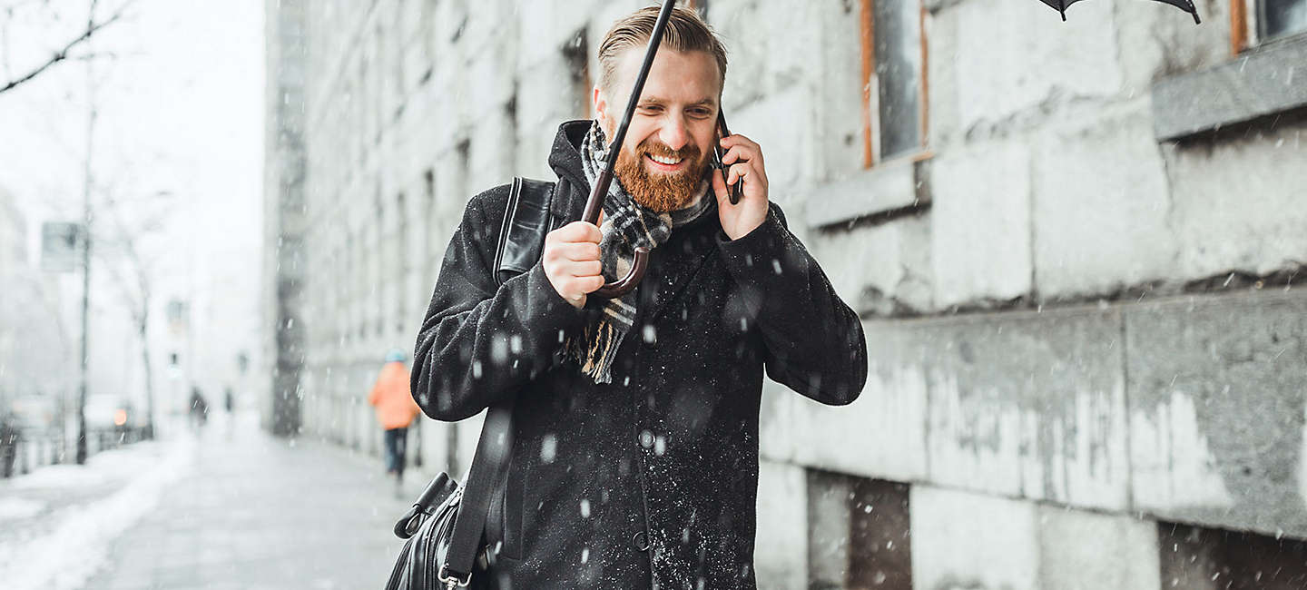 Man talking on phone in the snow