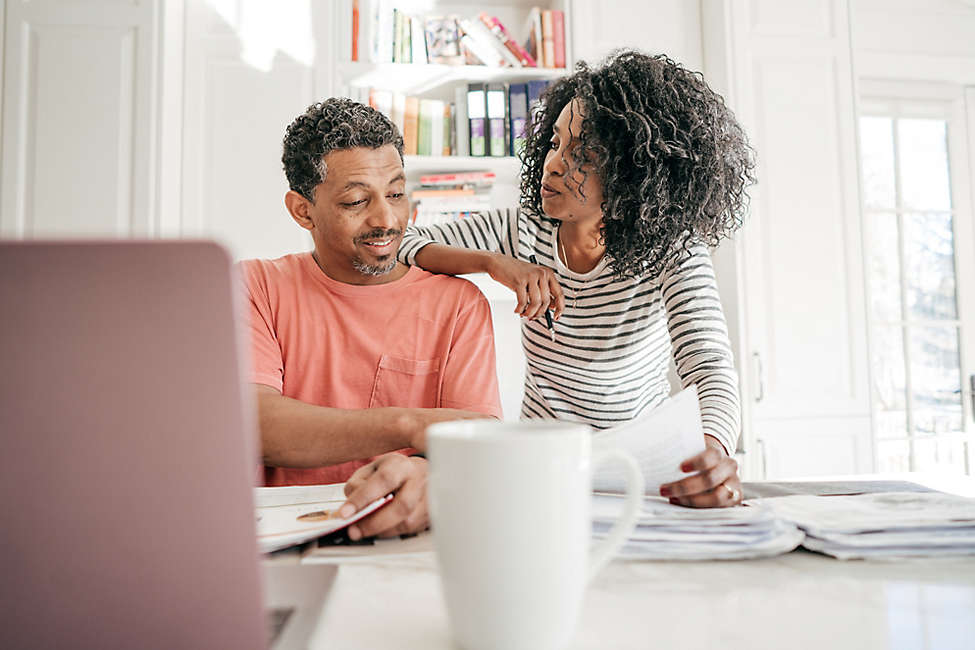 A husband and wife discussing their insurance policy.