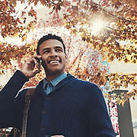 Man walking outside talking on his cell phone.