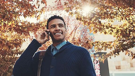 Man walking outside talking on his cell phone.