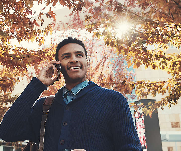 Man walking outside talking on his cell phone.