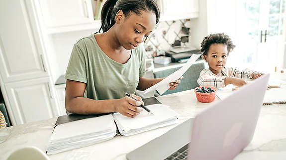 Woman sitting at table doing paperwork