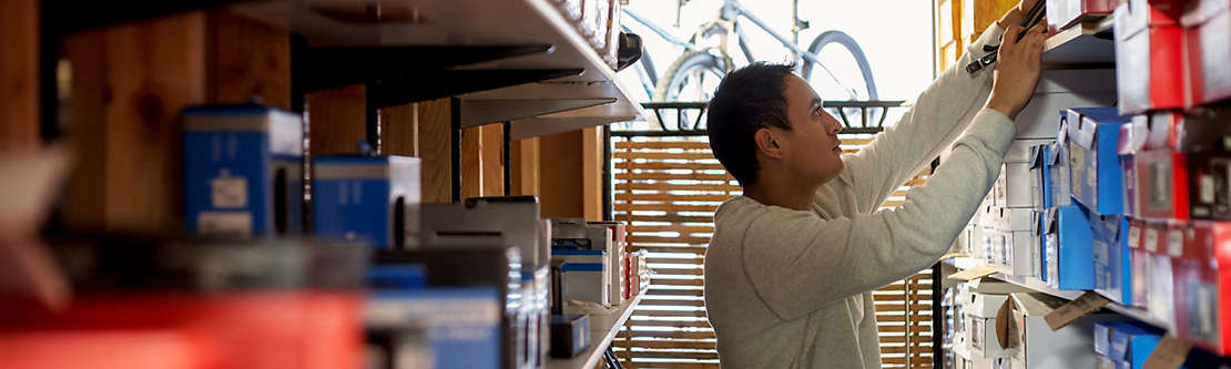 A man checking inventory in a bicycle shop.