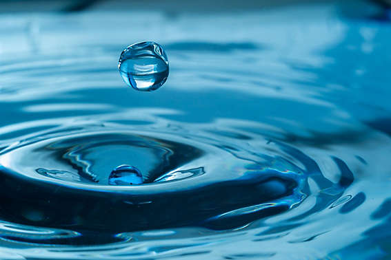 water drop splash in a glass blue colored