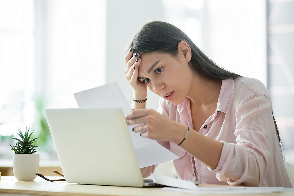 woman reading news about layoffs