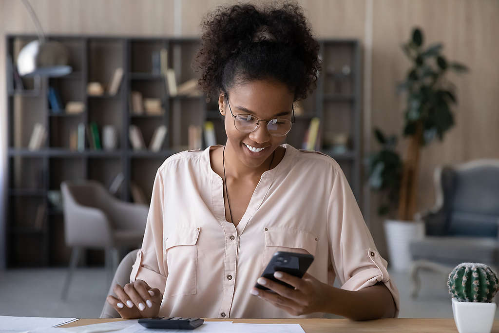 Young woman on her phone smiling