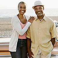Retied couple on the beach with a classic car