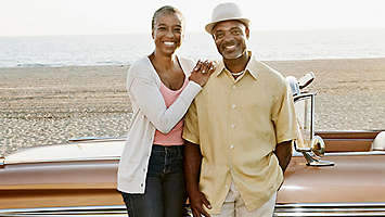 Retied couple on the beach with a classic car