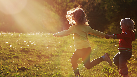 Kids running through the grass