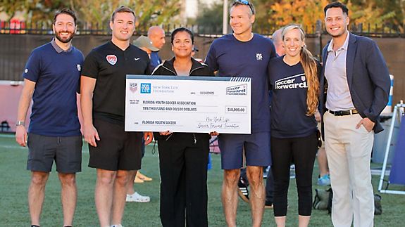 Volunteers from New York Life and Soccer Forward hosted a youth clinic featuring former USMNT players and presented a $10,000 contribution to the Florida Youth Soccer Association (FYSA)