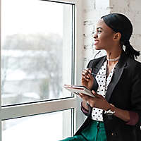 black woman smiling looking out window